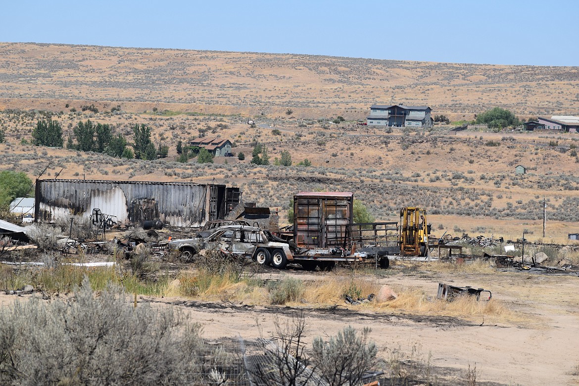 Shrubland near several homes burned and multiple small structures were damaged in what has been dubbed the Road 20 Fire Tuesday night.