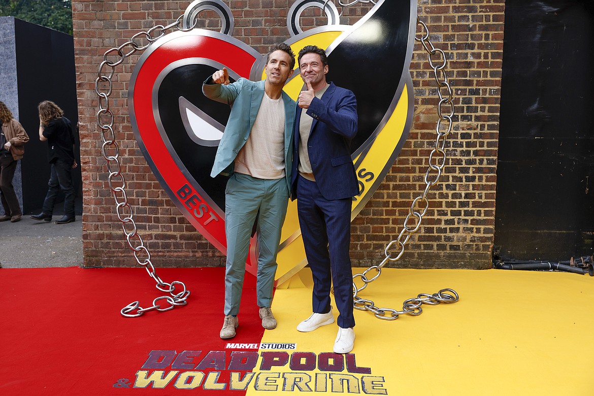 Ryan Reynolds, left, and Hugh Jackman pose for photographers upon arrival at the screening of the film "Deadpool & Wolverine" July 11 in London.