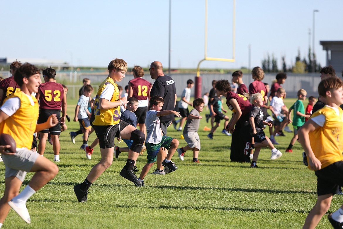 Moses Lake football players teach the youth campers how to warm up during this week’s Mav Youth Football Camp in Moses Lake.