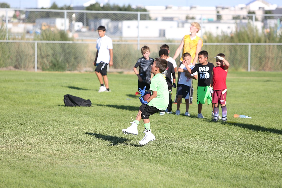 A player works on a route-running and catching drill at the Mav Youth Football Camp on Tuesday.