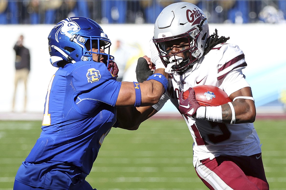 Montana running back Xavier Harris, right, runs with the football during the FCS Championship in Frisco, Texas. The FCS Championship is moving from Sunday afternoon to Monday night this season, which Big Sky Commissioner Tom Wistrcill said will be a “really big deal.”