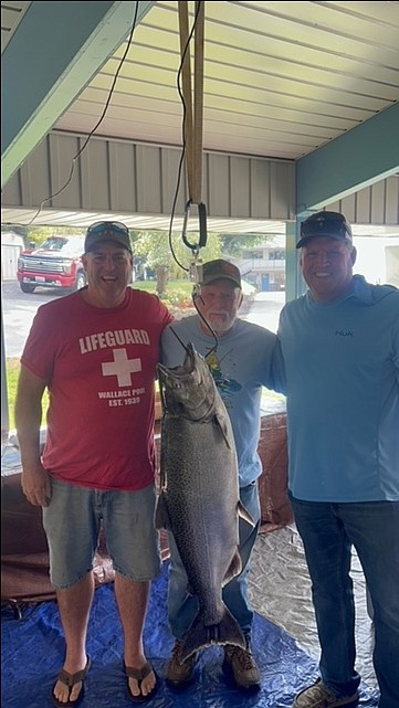 Carl Hojem and his sons, Bret (left) and Troy (right), pose with Carl's prize-winning catch.