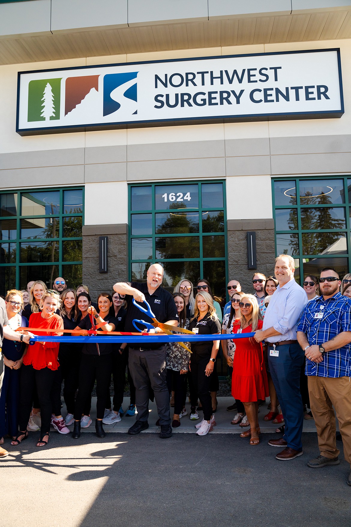 Rick Rasmussen, CEO for Northwest Specialty Hospital, cuts the ribbon for the opening of Northwest Surgery Center.