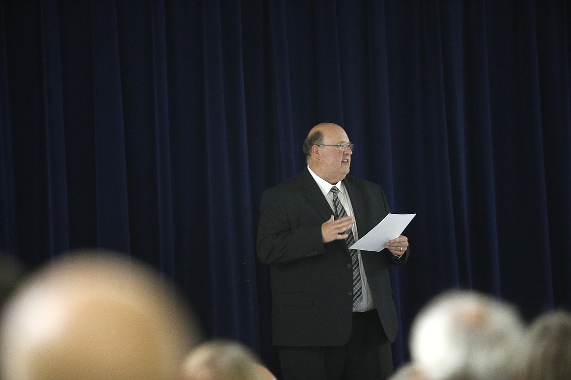 Spirit Lake property owner Stephen Ford addresses the crowd Thursday night about his application to remove the sandbar at Brickel Creek. He announced he will rescind the application.