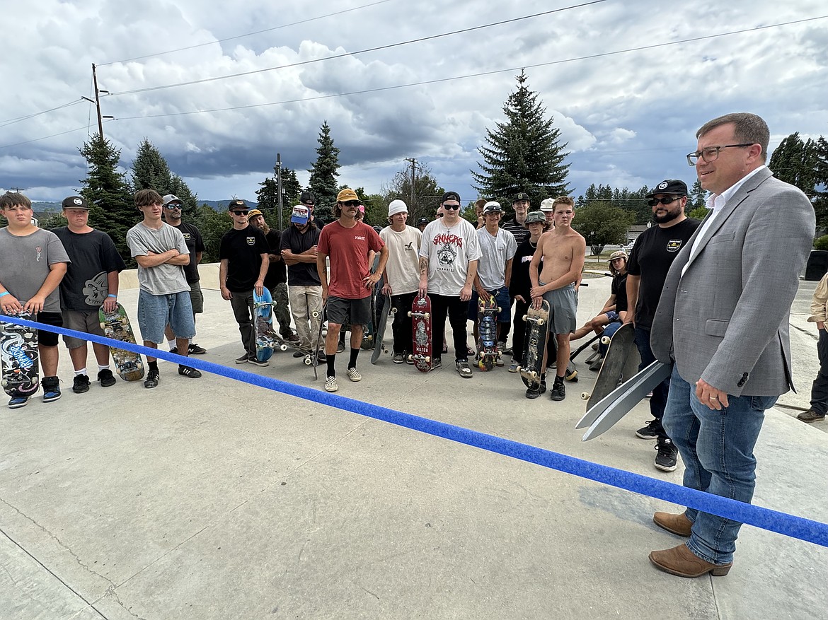 Sandpoint Mayor Jeremy Grimm talks to skateboarders Tuesday as he joined in a grand opening of the second phase of the Concrete Lake Skatepark.