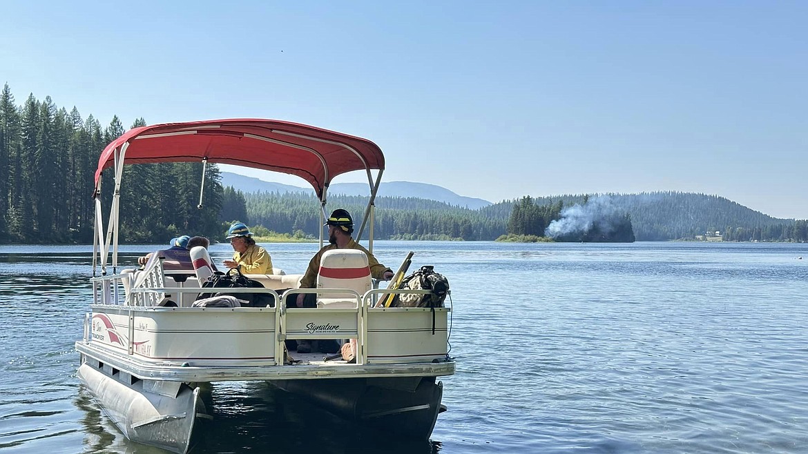 Olney residents ferry firefighters to an island on Lower Stillwater Lake on July 23. (Photo courtesy the Olney Fire Department)