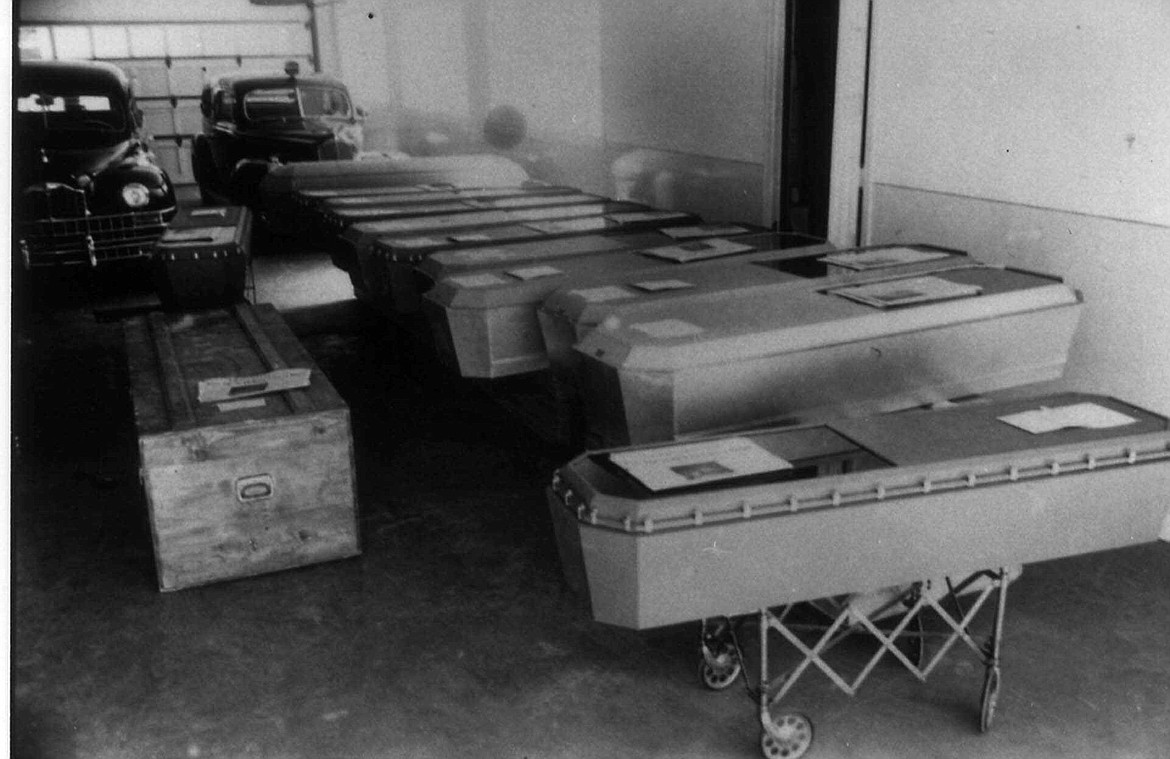 Caskets containing the bodies of Mann Gulch fire victims await shipment home to families in this August 1949 photo. The fire Aug. 5, 1949 near Helena, Mont., took the lives of 12 smokejumpers and a forest ranger. (AP Photo/Courtesy USDA Forest Service)