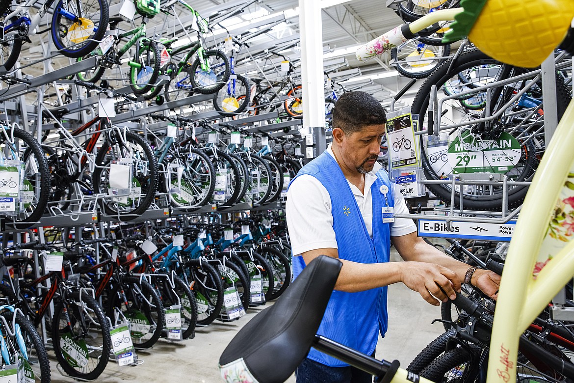 A worker organizes bicycles at a Walmart Superstore in Secaucus, New Jersey, July 11, 2024. Last month's rise in the unemployment rate has set off new worries about the threat of a recession, but it could also be a false alarm. The distorted post-pandemic economy has already confounded a host of traditional recession signals, at least so far. (AP Photo/Eduardo Munoz Alvarez, File)