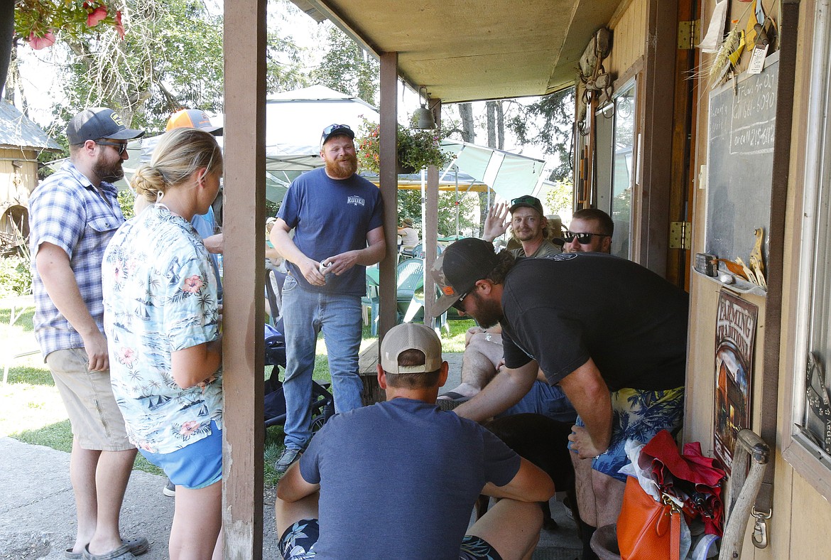 Cousins converge on a porch July 20 during the Scarcello summer gathering at Laurin Scarcello's Rathdrum ranch. A celebration is held every other year to commemorate the founding of the farm by four Scarcello brothers from Italy in 1910.