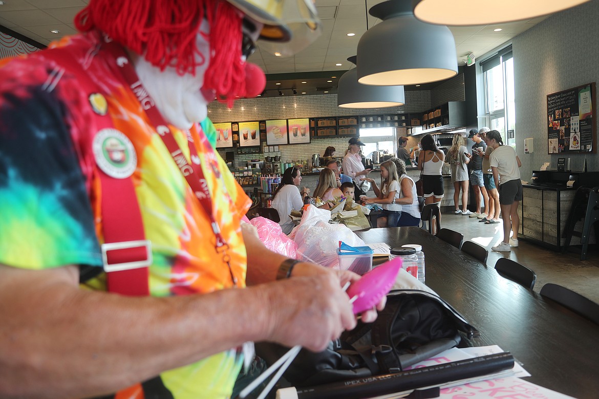 Chuck "Doc" Schoonover sets up a flock of flamingos during a flocking of the Ponderay Starbucks on Friday. The event was held to raise money to relaunch the local club and to help Shriners Children's.