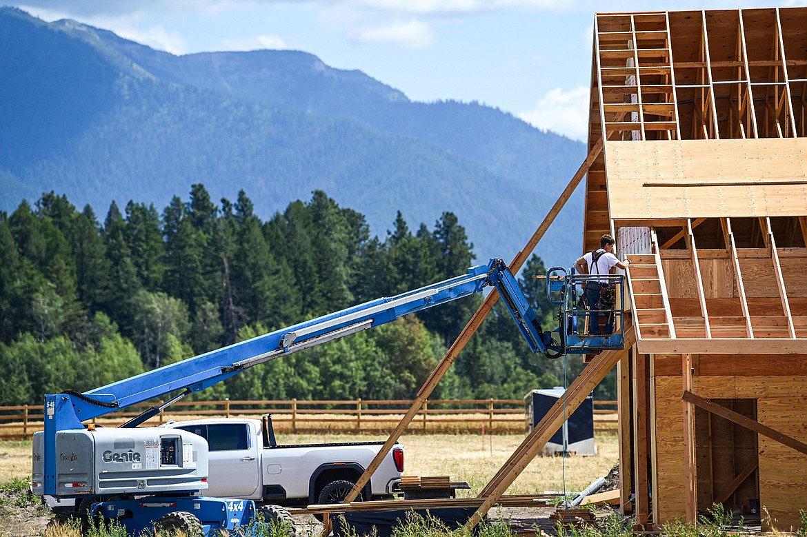 A builder works on a home under construction along Montford Road on Wednesday, July 31. (Casey Kreider/Daily Inter Lake)