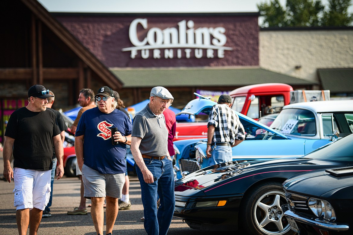 Visitors walk through rows of vehicles at the Evergreen Show N' Shine at Conlin's Furniture on Saturday, Aug. 3. (Casey Kreider/Daily Inter Lake)