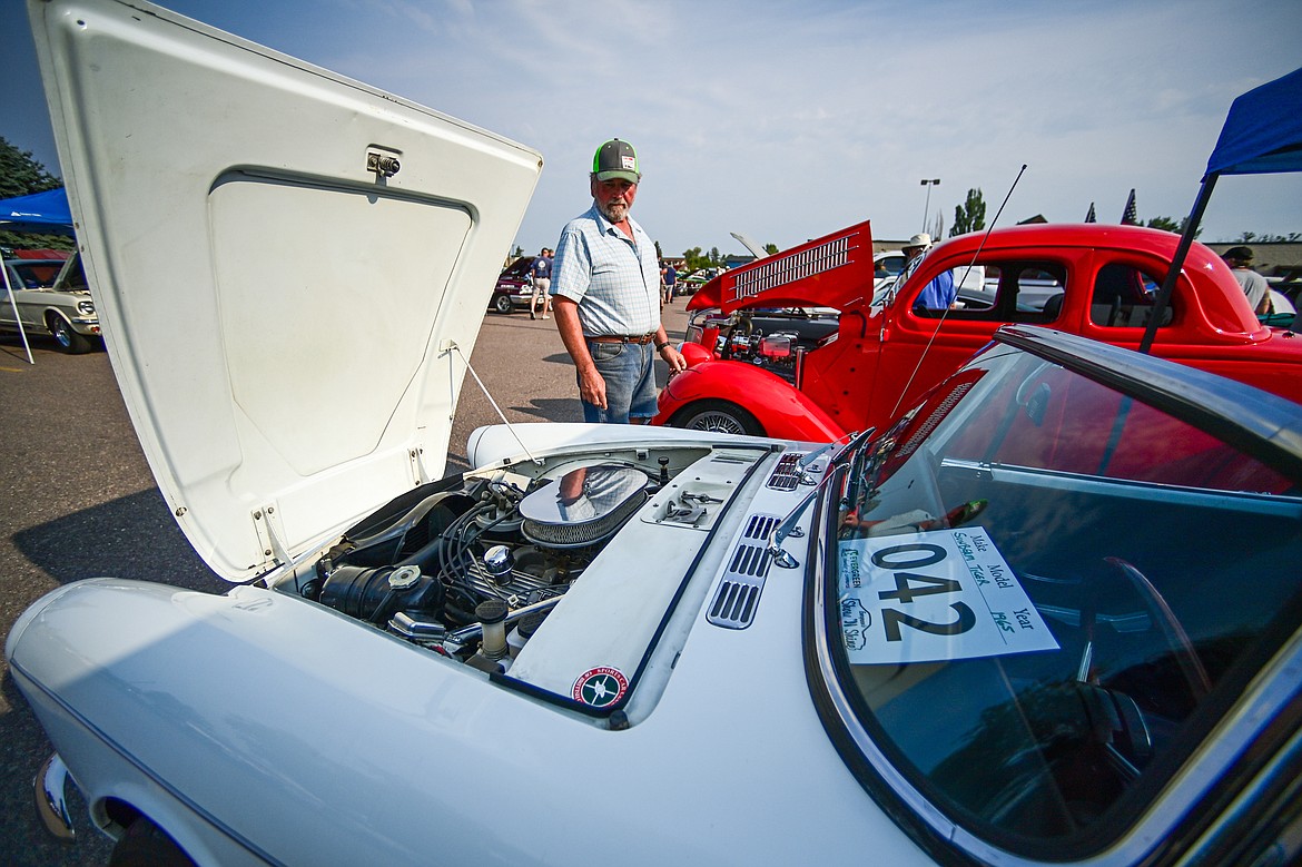 A visitor checks out a 1965 Sunbeam Tiger at the Evergreen Show N' Shine at Conlin's Furniture on Saturday, Aug. 3. (Casey Kreider/Daily Inter Lake)