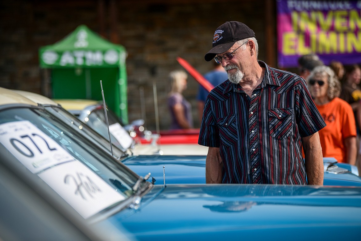 Visitors check out rows of classic cars, trucks, motorcycles and off-road vehicles at the Evergreen Show 'N Shine at Conlin's Furniture on Saturday, Aug. 3. (Casey Kreider/Daily Inter Lake)