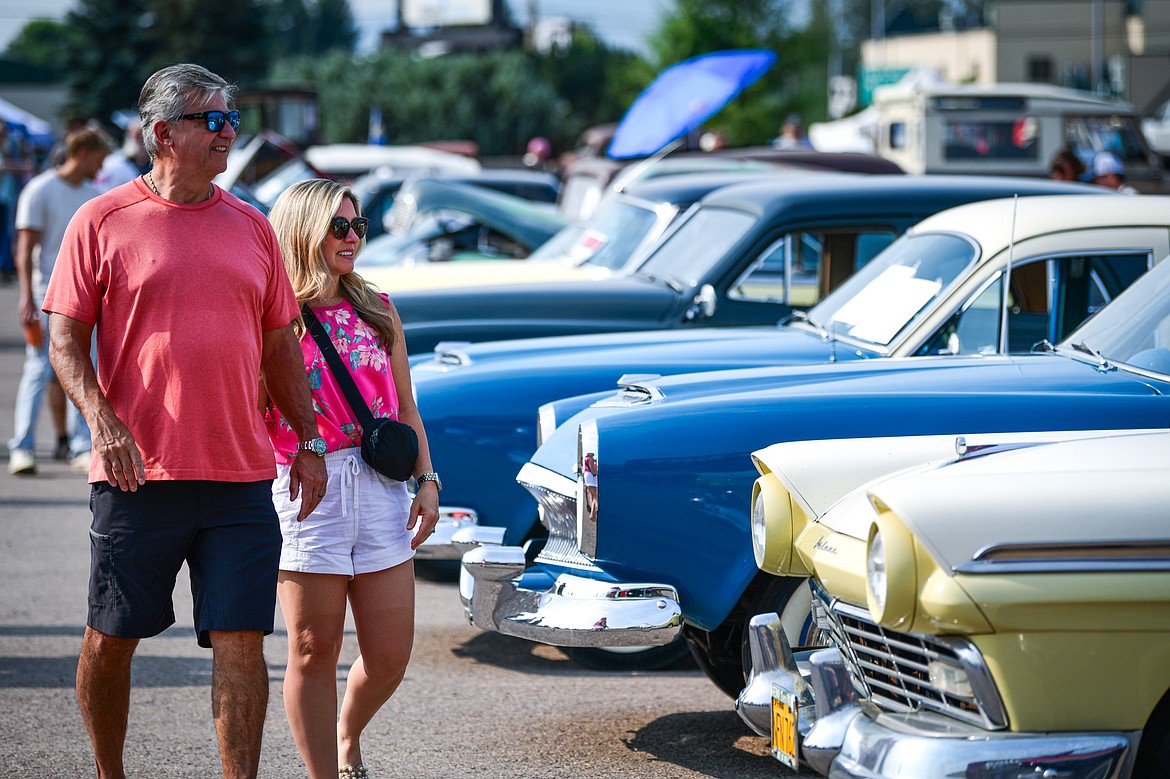 Visitors check out rows of classic cars, trucks, motorcycles and off-road vehicles at the Evergreen Show 'N Shine at Conlin's Furniture on Saturday, Aug. 3. (Casey Kreider/Daily Inter Lake)