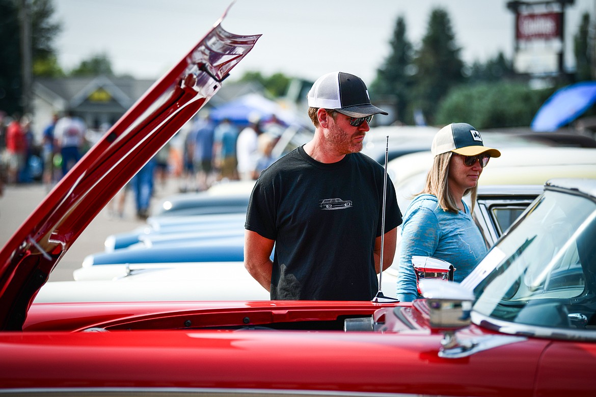 Visitors check out rows of classic cars, trucks, motorcycles and off-road vehicles at the Evergreen Show 'N Shine at Conlin's Furniture on Saturday, Aug. 3. (Casey Kreider/Daily Inter Lake)