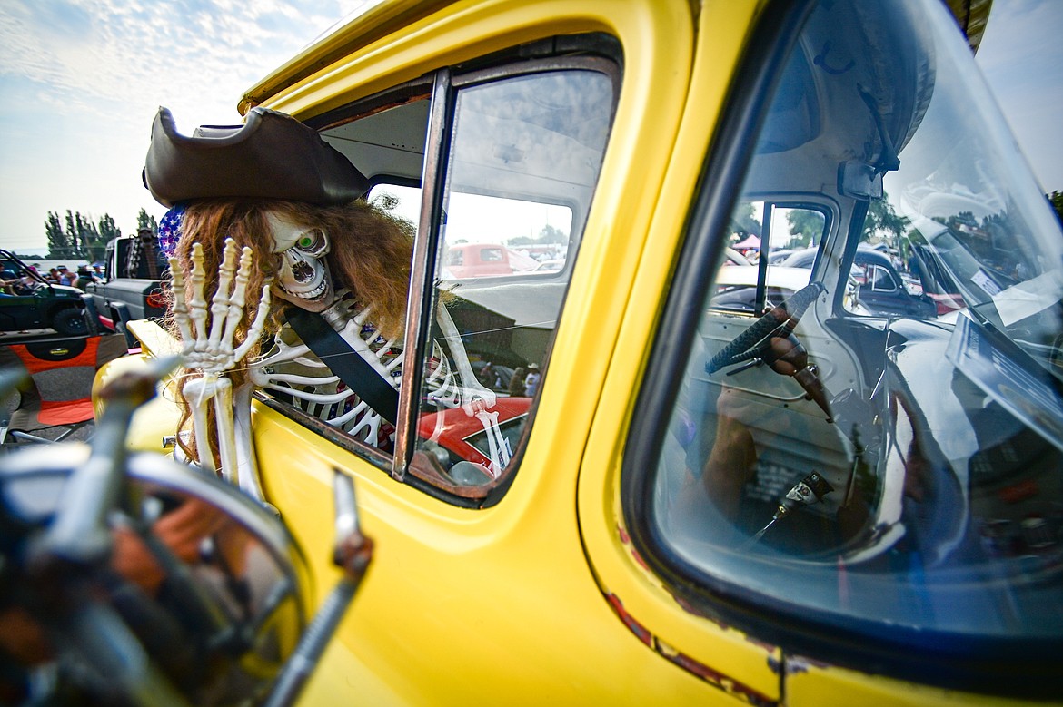 A skeleton waves from the passenger seat of a 1959 Chevy Apache pickup at the Evergreen Show 'N Shine at Conlin's Furniture on Saturday, Aug. 3. (Casey Kreider/Daily Inter Lake)