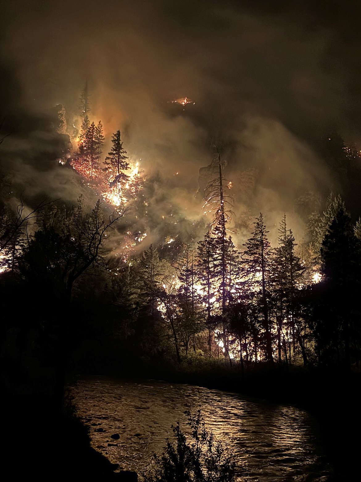 The Retreat Fire, located in Yakima County fills the night sky with orange flames and smoke. The fire is the third largest in Washington on Saturday at almost 35,000 acres.