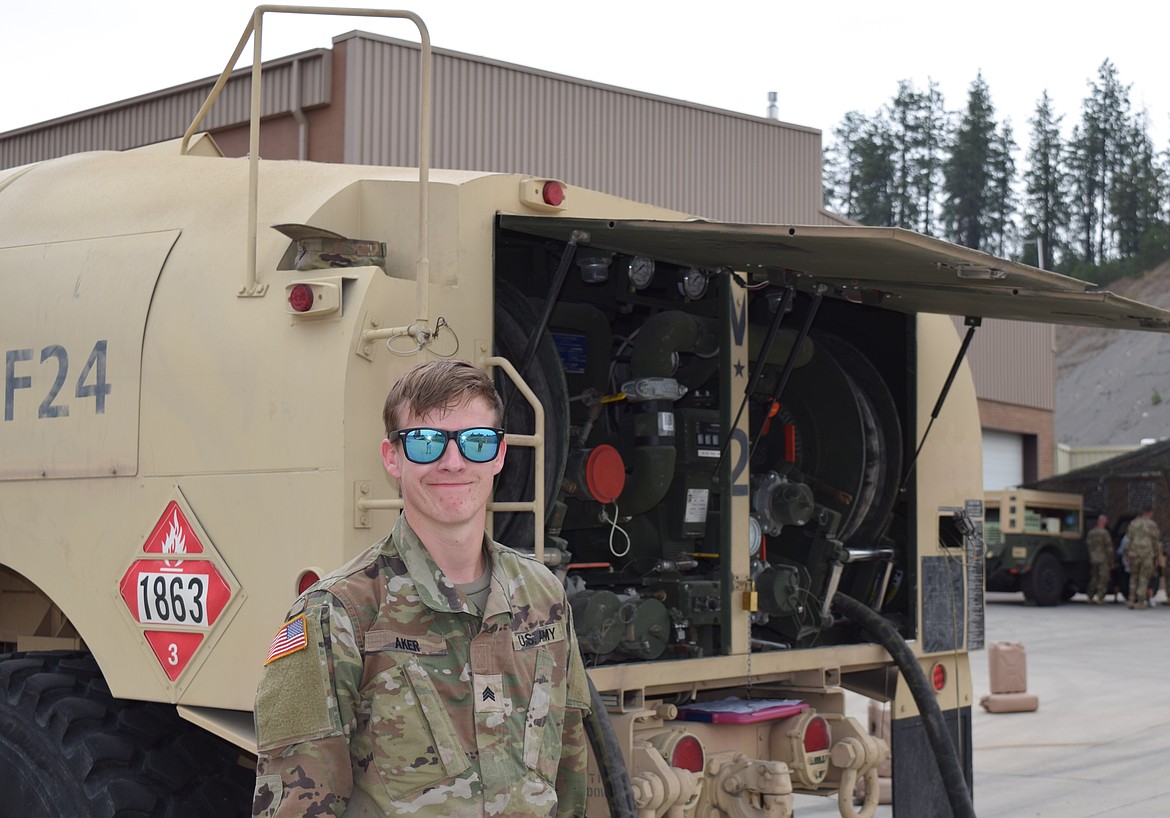 Sargeant Thomas Aker stands beside a Heavy Expandable Mobile Tactile Truck at Saturday's open house. The fuel truck hold 2,500 gallons of fuel and is used to refuel both ground and aerial vehicles.