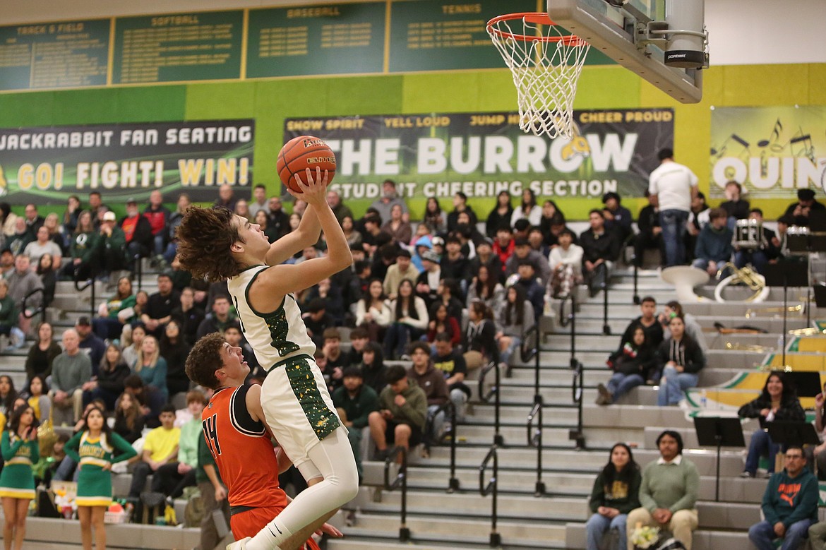 Quincy’s Pierce Bierlink moves toward the rim on a lay-up attempt during the second half of a game against Cashmere last season.