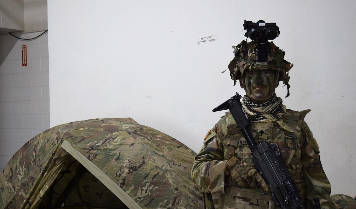 Specialist Colton Kress, Bravo Co. 145th Support Brigade Battalion, puts camouflage skills to use during a gear demonstration.