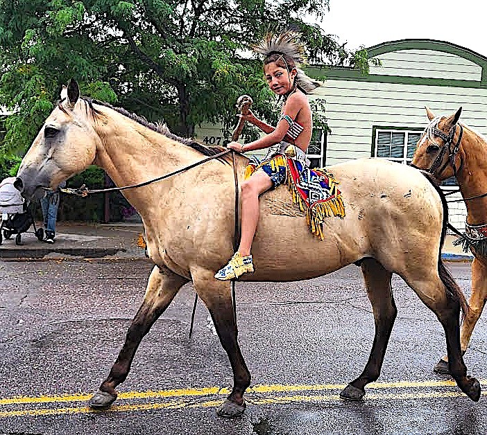 One of the Pistol Creek group rides a big buckskin and wears Native American regalia. (Berl Tiskus/Leader)