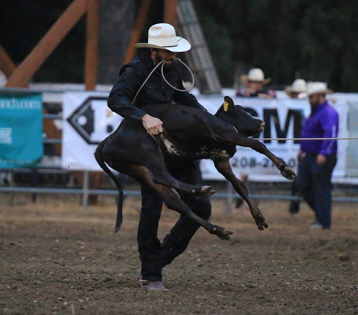 Former Montana State University quarterback and Manhattan High (Mont.) football star, Quinn McQueary, competes in the tie-down roping competition during the Sandpoint Rodeo's second day of action.