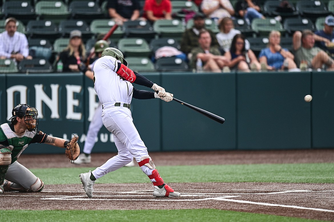 Glacier's Chad Castillo (28) connects on a single in the fourth inning against the Missoula Paddleheads at Glacier Bank Park on Tuesday, Aug. 6. (Casey Kreider/Daily Inter Lake)