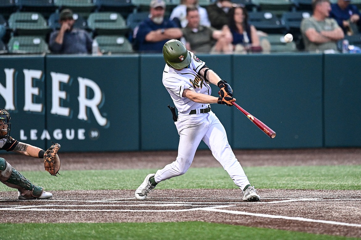 Glacier's Andy Atwood (21) knocks a sacrifice fly into right field scoring Christian Kirtley in the sixth inning against the Missoula Paddleheads at Glacier Bank Park on Tuesday, Aug. 6. (Casey Kreider/Daily Inter Lake)