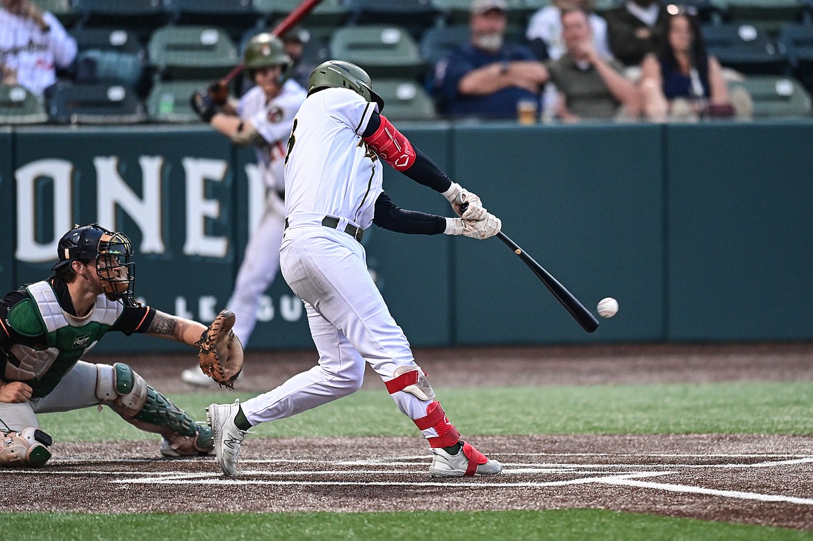 Glacier's Chad Castillo (28) connects on a single in the sixth inning against the Missoula Paddleheads at Glacier Bank Park on Tuesday, Aug. 6. (Casey Kreider/Daily Inter Lake)