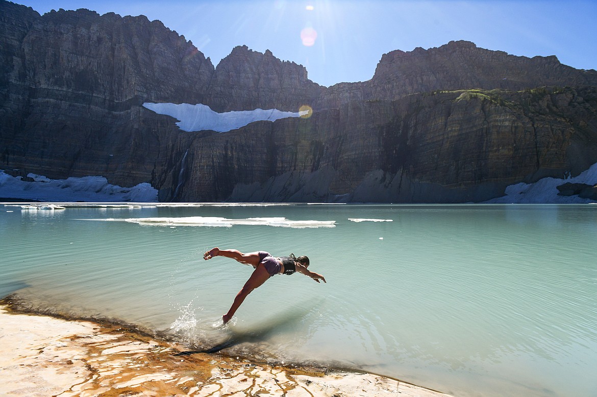 Suzanne Buttenob dives into Upper Grinnell Lake in Glacier National Park on Thursday, Aug. 1. Buttenob and her friend Braxton Smith drove through the night from Salt Lake City to hike the Grinnell Glacier trail. (Casey Kreider/Daily Inter Lake)