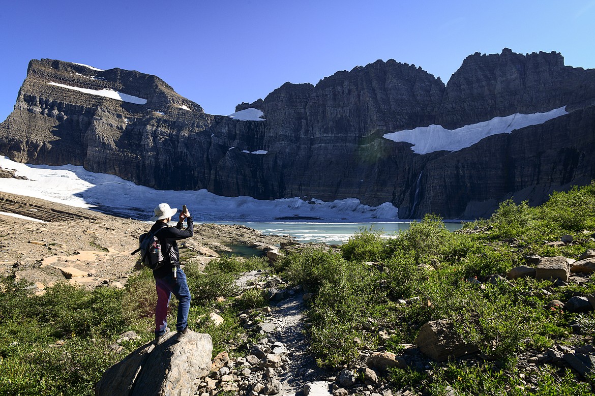 A hiker takes a photograph as he arrives at Upper Grinnell Lake in Glacier National Park on Thursday, Aug. 1. (Casey Kreider/Daily Inter Lake)