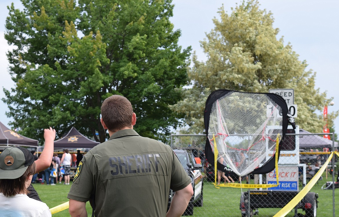 National Night Out attendees got a chance to test their throwing arms with the Kootenai County Sheriff's Office by seeing how fast they can throw against a roadside speedometer.