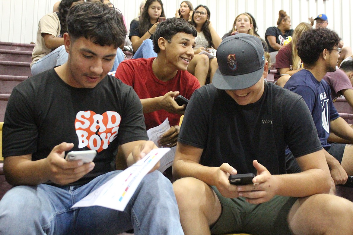 Wrestlers work their way down the list of possible donors during the fundraiser for Moses Lake extracurricular activities.