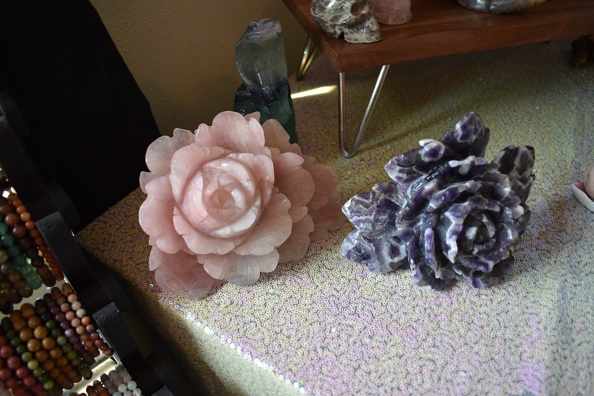 These hand-carved roses for sale by Fairygenix are made of rose quartz, left, and dream amethyst. Owner Tia Seibel keeps most of her stock in a room in her apartment and sells at pop-ups and festivals, which lets her keep her prices low.