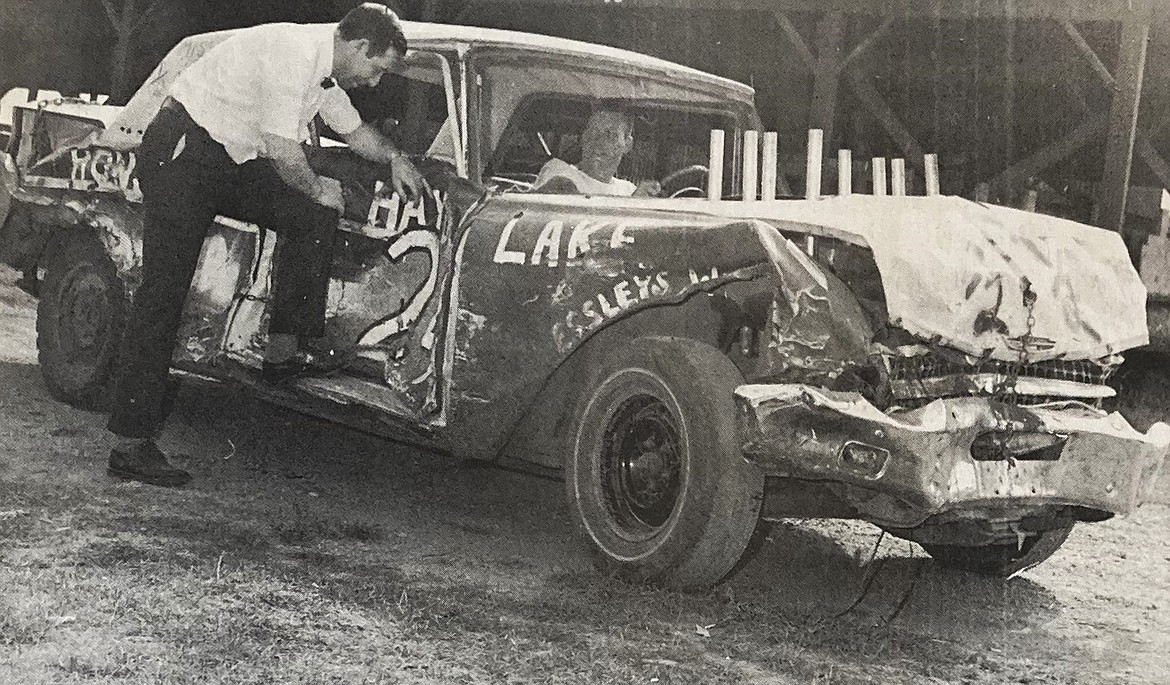 In 1974, Sponsor Ron McIntire talked with Henry Browning, driving Miss Half ‘n Half, prior to a demolition derby.