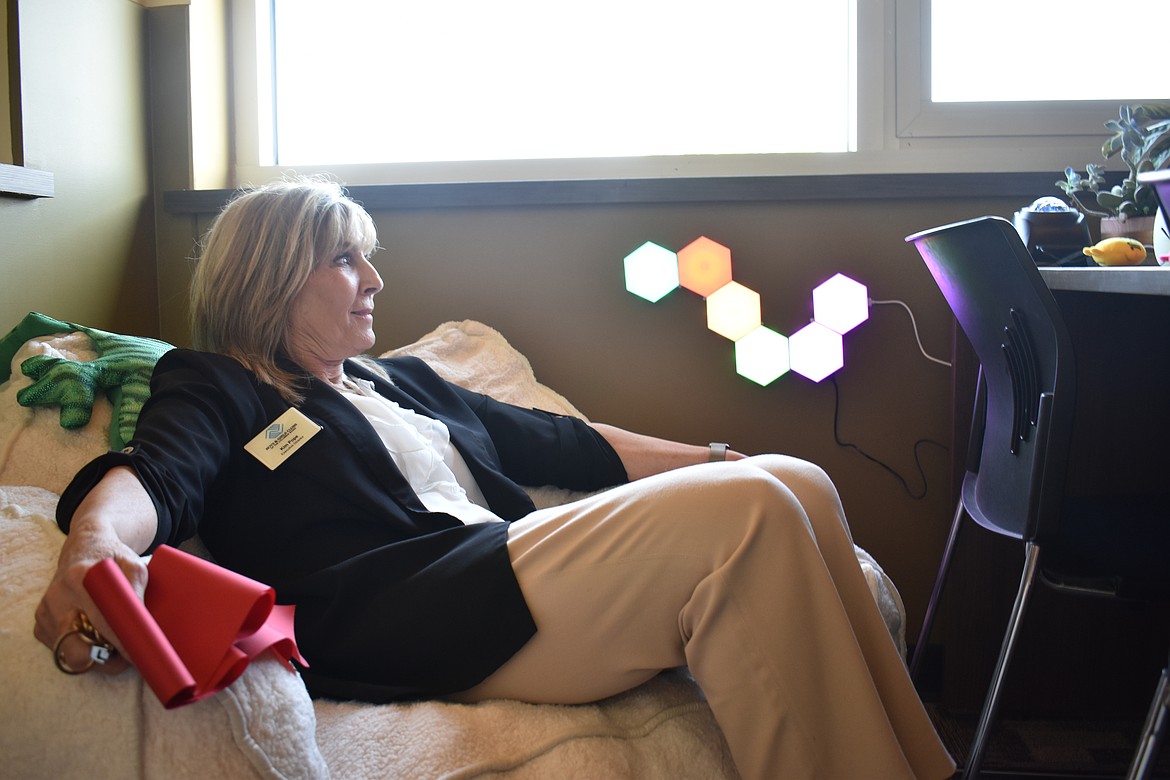 Boys & Girls Clubs of the Columbia Basin Executive Director Kim Pope sits in one of the comfy chairs in the club’s new Mental Health Quiet Room after the ribbon-cutting Tuesday. The stuffed frog behind her shoulder is weighted for children with sensory issues.