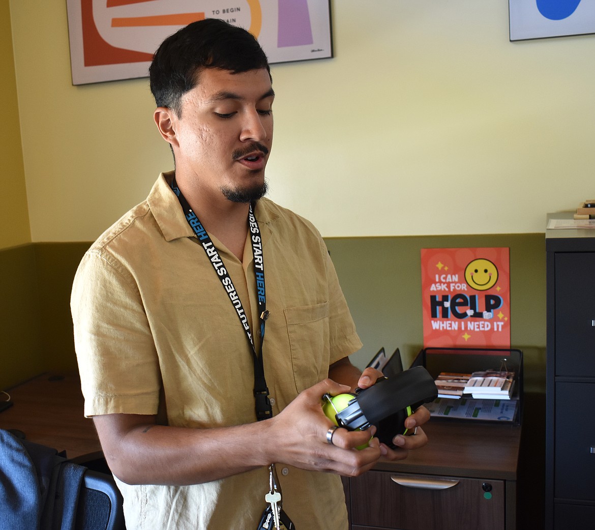 Boys & Girls Clubs of the Columbia Basin Behavioral Support Specialist Santiago Alba shows a pair of ear protectors, for children who want to play outside the quiet room but need to keep out the outside noise.