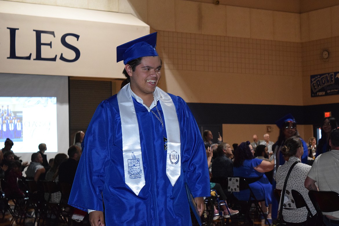 A Soap Lake grad smiles during this spring's graduation ceremony at Soap Lake High School. The school district recently passed its budget for the year and hopes to continue pushing students through to graduation despite somewhat tight resources.