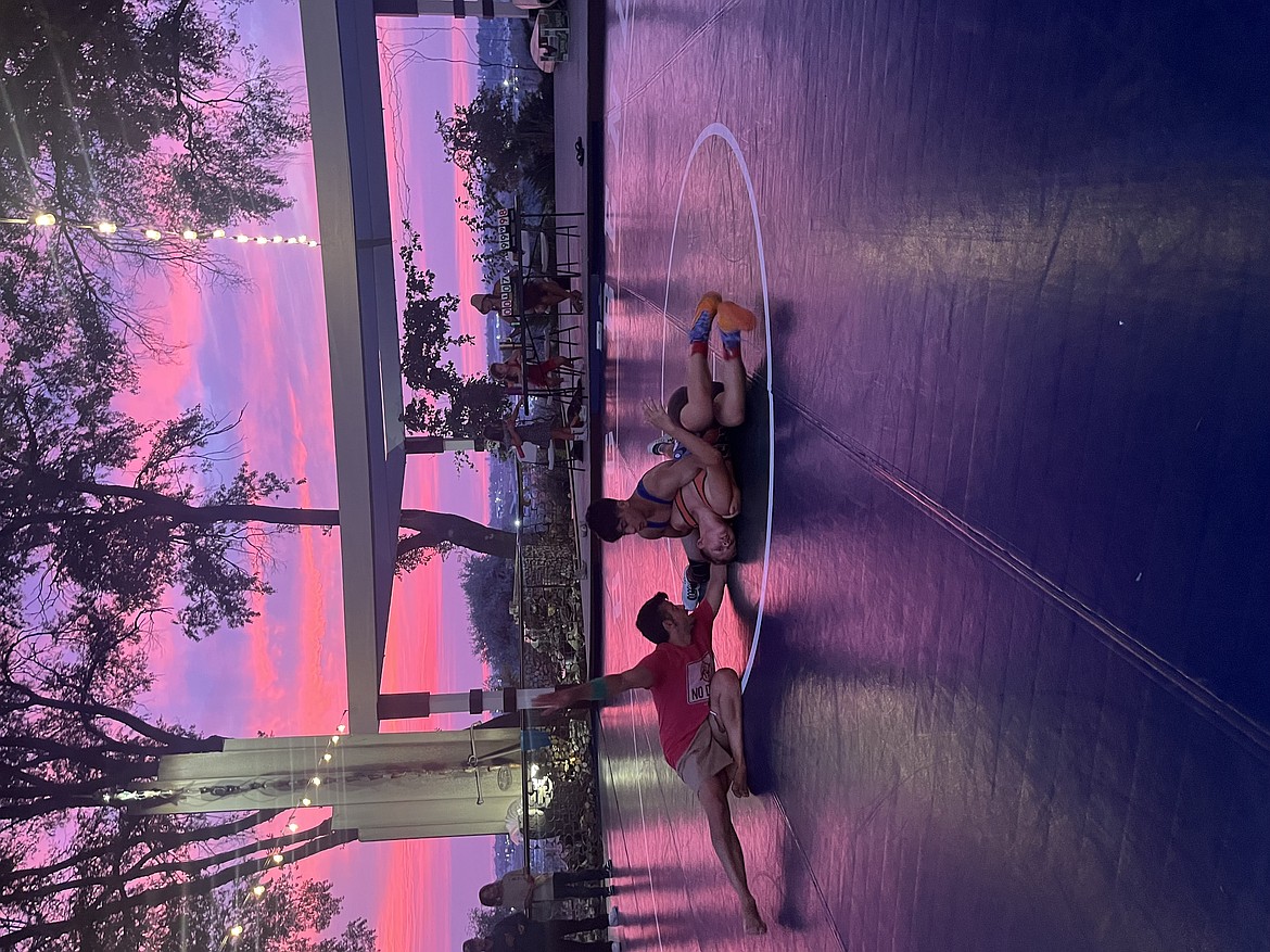 Campers wrestle under the sunset at Zamora Park on Saturday. The camp was held at both Zamora Park and Moses Lake High School over the weekend.