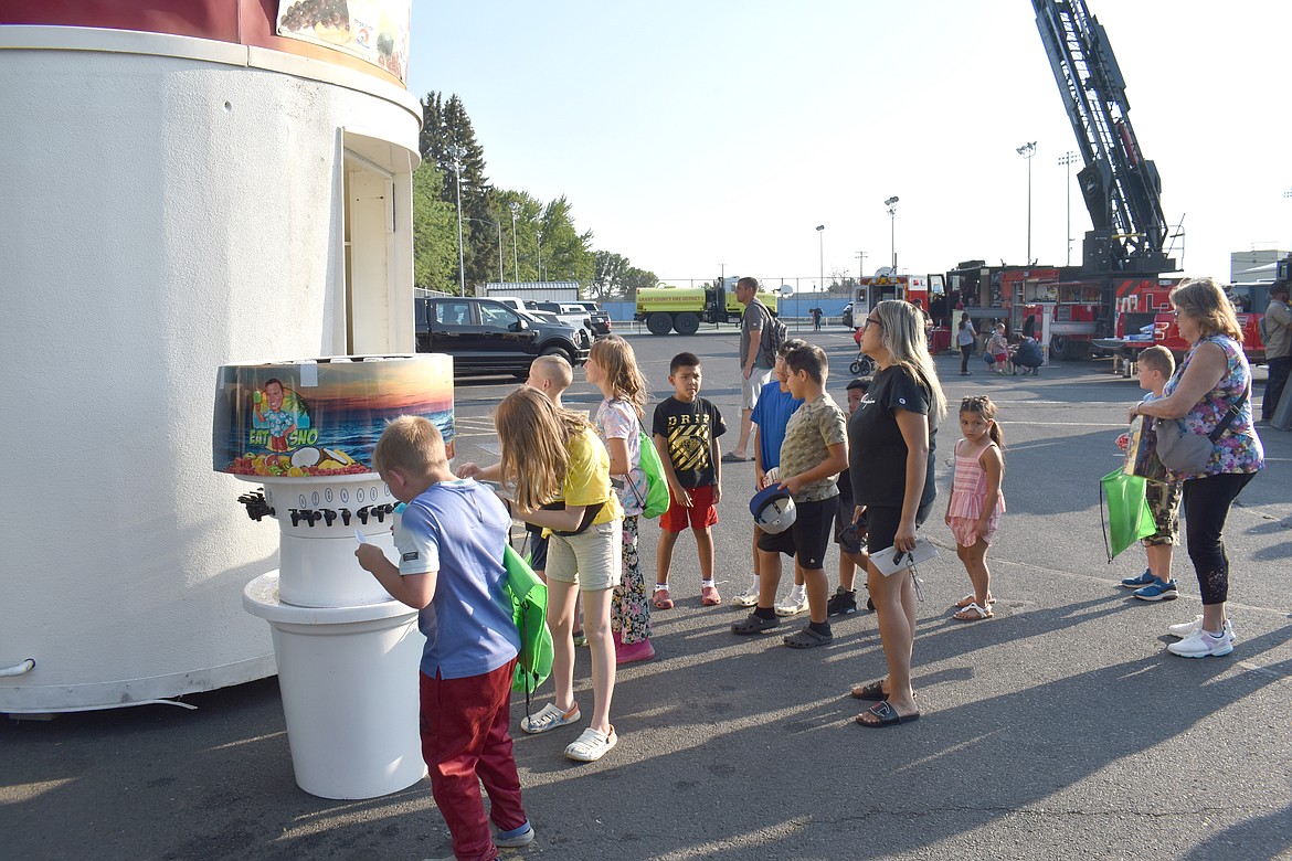 The 95-degree weather made the snow cone booth a popular stop at National Night Out in Moses Lake Tuesday.