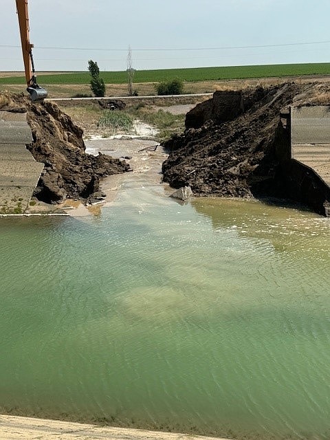 A break in the East Low Canal northeast of Moses Lake left water across the roadway on Road N Northeast.