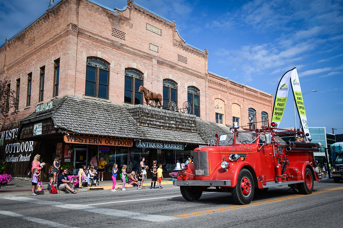 A vintage fire truck rolls down Main Street during the Northwest Montana Fair Parade in Kalispell on Friday, Aug. 9. (Casey Kreider/Daily Inter Lake)