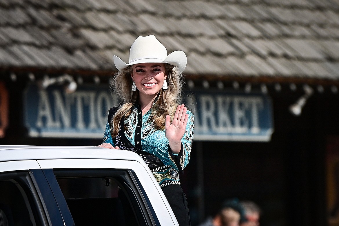 Cody Carson, 2024 Miss Northwest Montana Rodeo, waves from a pickup truck during the Northwest Montana Fair Parade in Kalispell on Friday, Aug. 9. (Casey Kreider/Daily Inter Lake)