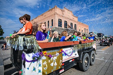 Kalispell Montessori students blow bubbles from a float during the Northwest Montana Fair Parade in Kalispell on Friday, Aug. 9. (Casey Kreider/Daily Inter Lake)