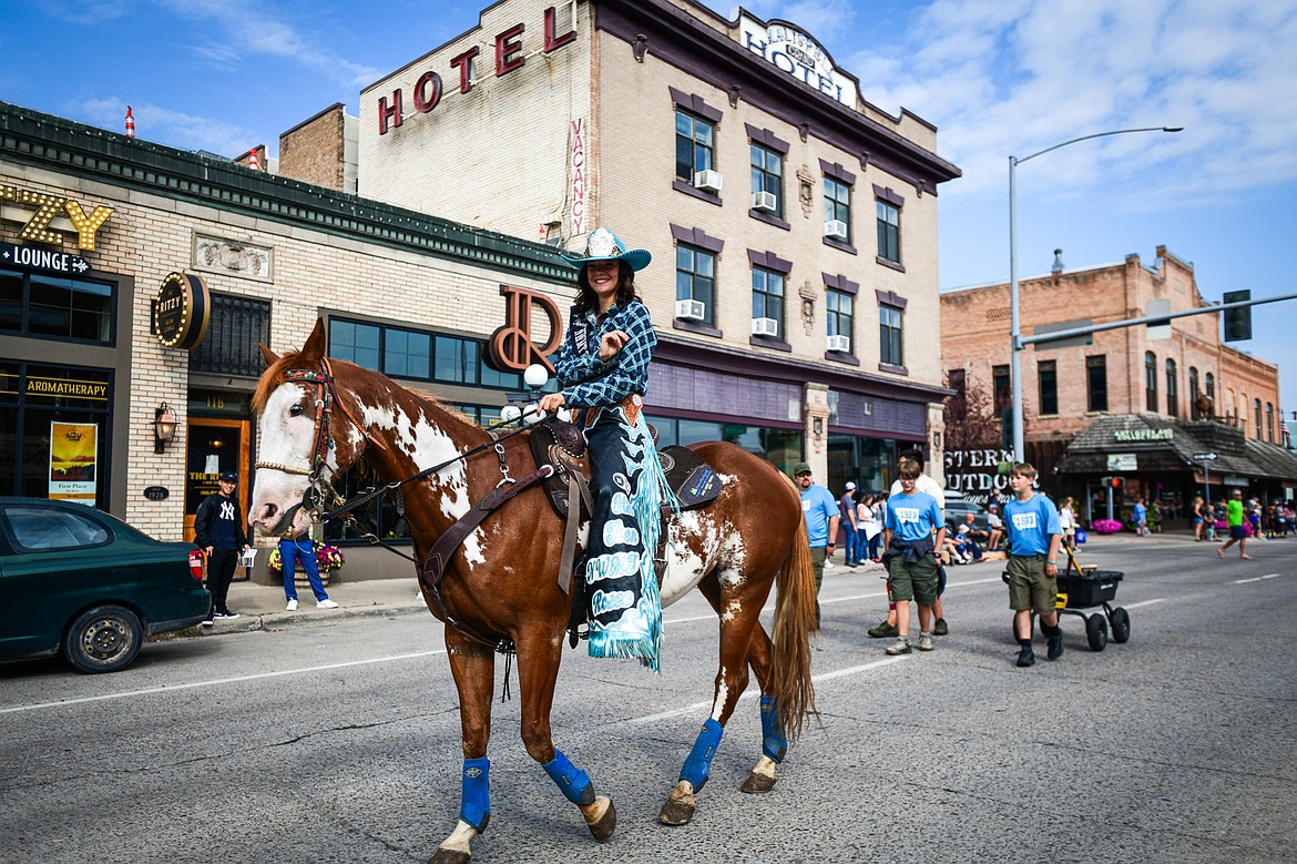 Miss Teen Northwest Montana Rodeo rides a horse down Main Street during the Northwest Montana Fair Parade in Kalispell on Friday, Aug. 9. (Casey Kreider/Daily Inter Lake)