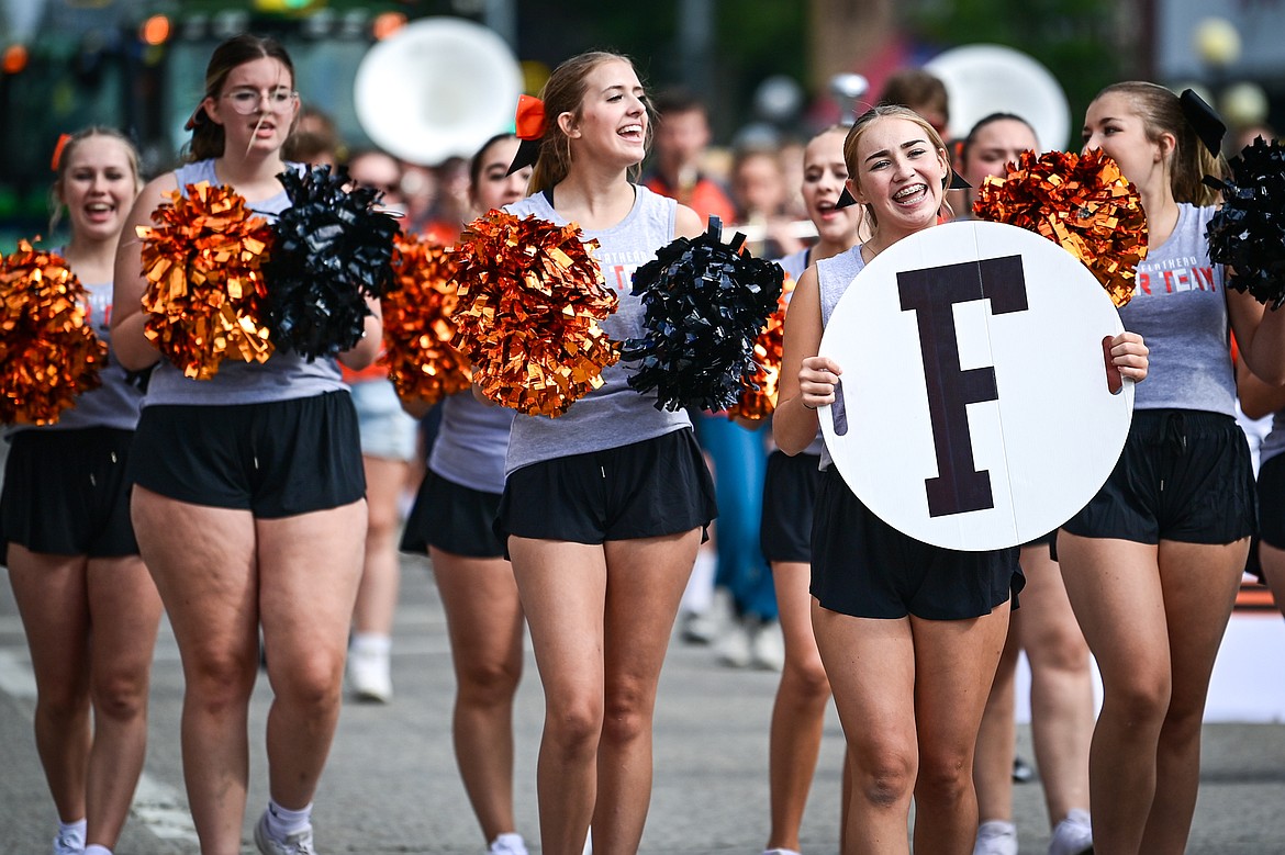 Flathead High School cheerleaders walk down Main Street during the Northwest Montana Fair Parade in Kalispell on Friday, Aug. 9. (Casey Kreider/Daily Inter Lake)