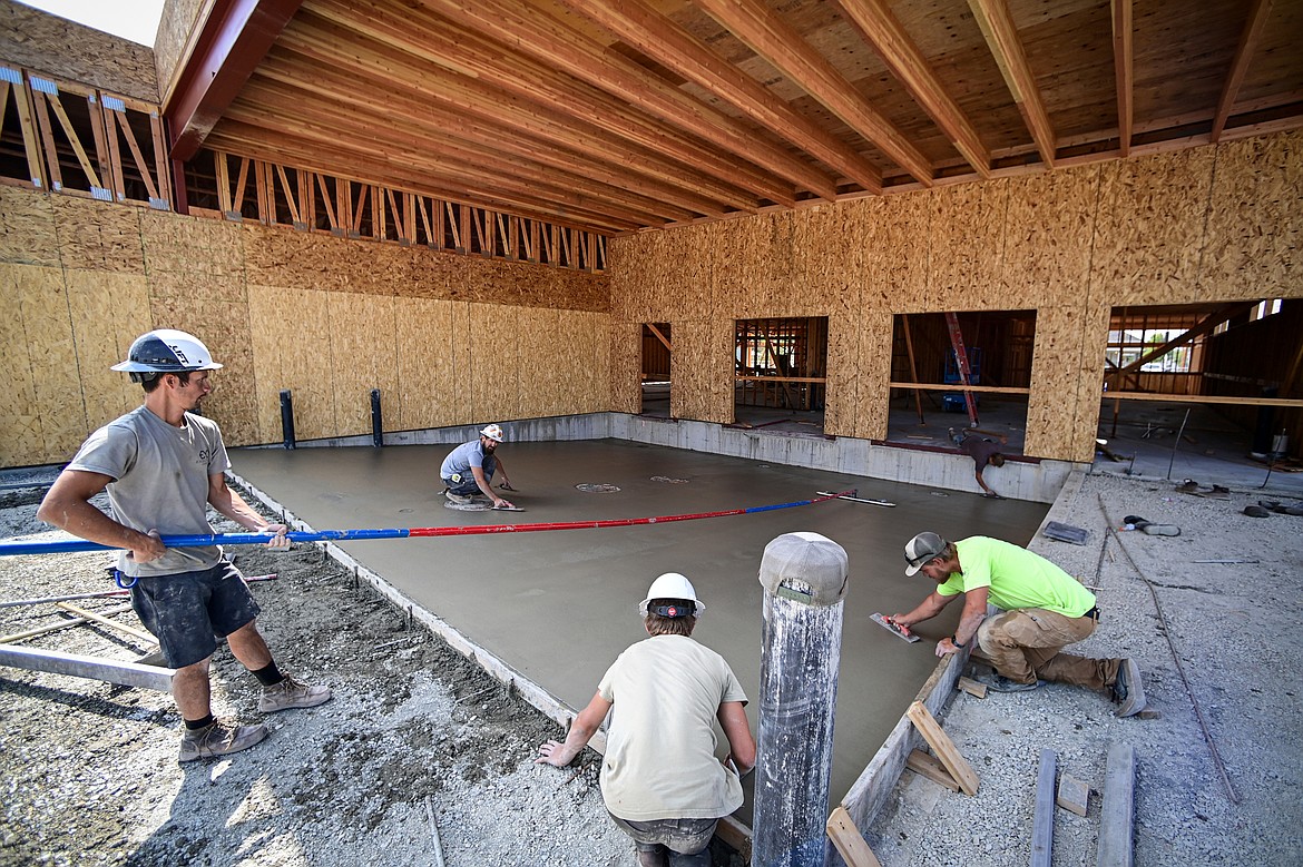 A crew with Exocrete floats concrete at the site of Flathead Industries' clearance store along East Montana Street on Friday, Aug. 9. (Casey Kreider/Daily Inter Lake)