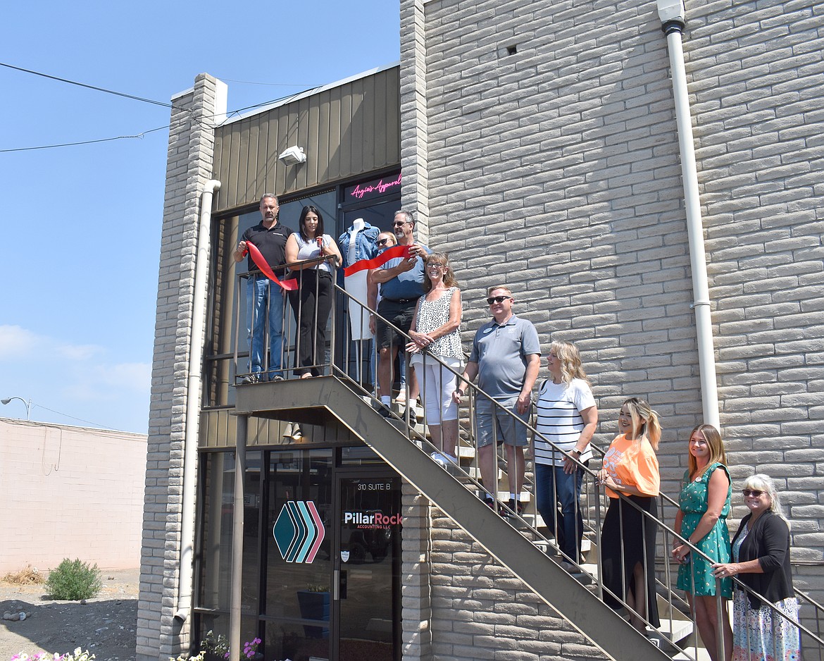 Angie Delgado, flanked by members of the Moses Lake Chamber of Commerce, cuts the ribbon on her shop, Angie’s Apparel. The shop is located upstairs in the back of the building at 310 S. Balsam St.