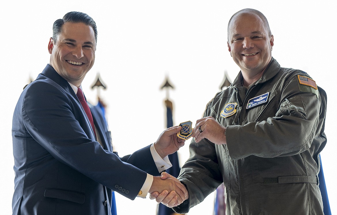 Col. Chad Cisewski, right, 92nd Air Refueling Wing commander, and Heath Mello, a representative of the Strategic Command Consultation Committee, exchange a coin and a patch during the Omaha Trophy presentation ceremony at Fairchild Air Force Bas Aug. 7.